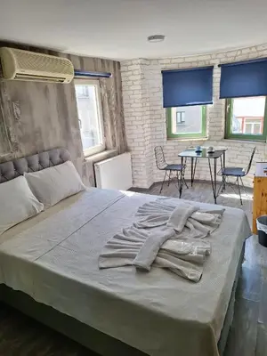 a large bed in a room with chairs and a table at Hendec 7 Apartments Near Galataport in Istanbul