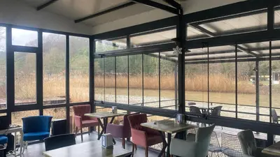 a room with tables and chairs and large windows at Ağva Capella Hideaway Hotel in Sile