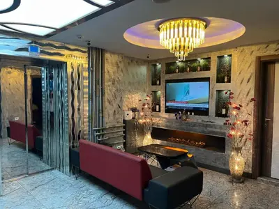 a lobby with a tv and a couch and a table at HEVİN Otel in Bursa