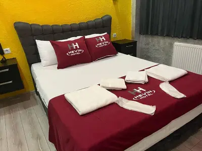 a bed with red and white towels on it at HEVİN Otel in Bursa