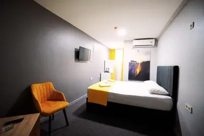 a small room with a bed and a chair at Polo Suit Otel in Avcılar