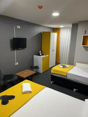 a hotel room with two beds and a tv at Polo Suit Otel in Avcılar
