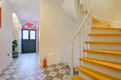 a hallway with stairs and a blue door at Casa Nozze 3 in Istanbul