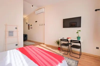 a bedroom with a bed and a table with two chairs at Casa Nozze 3 in Istanbul