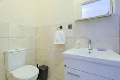 a bathroom with a white toilet and a sink at Casa Nozze 3 in Istanbul