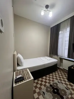 a small room with a bed and a window at Fındık Palas Otel in Istanbul