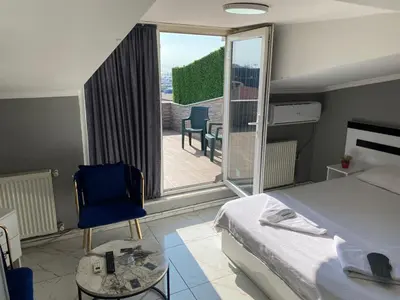 a bedroom with a bed and a view of a patio at My King Suit in Istanbul