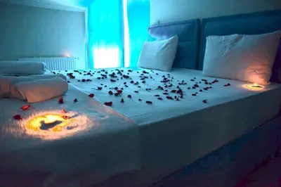 a bed with a bunch of flower petals on it at My King Suit in Istanbul