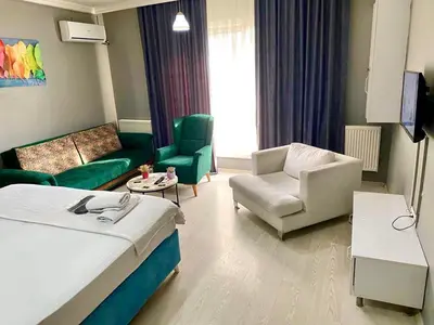 a hotel room with a bed and a living room at My King Suit in Istanbul