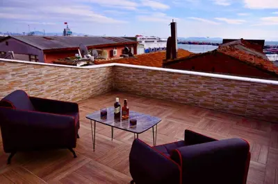 a patio with two chairs and a table on a roof at My King Suit in Istanbul