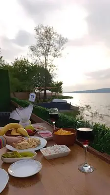 a table with plates of food and glasses of wine at Flamingo Adalife in Sapanca