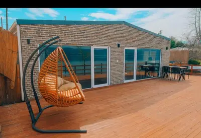 a basket swing on a deck with a house at Flamingo Adalife in Sapanca