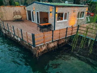 a tiny house on a dock in the water at Flamingo Adalife in Sapanca