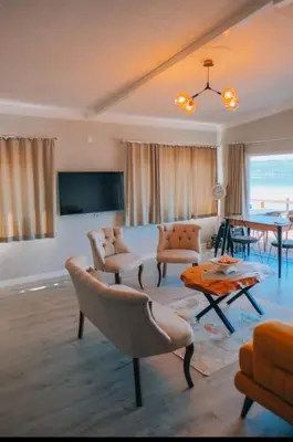 a living room with a couch and a table at Flamingo Adalife in Sapanca