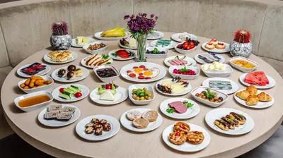 a table with plates of food on top of it at Kent Hotel Beyazıt in Istanbul