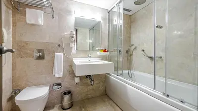 a bathroom with a toilet and a sink and a shower at Kent Hotel Beyazıt in Istanbul