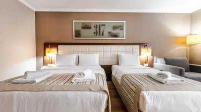 a hotel room with two beds with towels on them at Kent Hotel Beyazıt in Istanbul