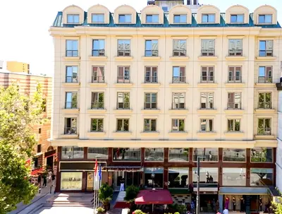 a large white building on a city street at Kent Hotel Beyazıt in Istanbul