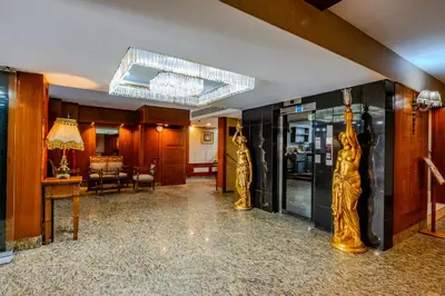 a lobby with two statues of women on the wall at Peak Star Hotel in Istanbul