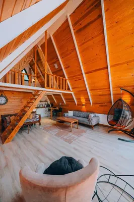 a living room with a wooden ceiling and a staircase at Mert Bungalov-Yıldız Evi in Sapanca
