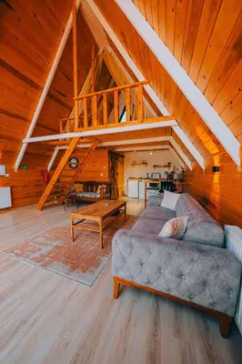 a living room with a couch and a staircase at Mert Bungalov-Yıldız Evi in Sapanca