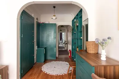 a hallway with green doors and a wooden floor at Chic 2BR Gem on Moda Iconic Antiques Street in Istanbul