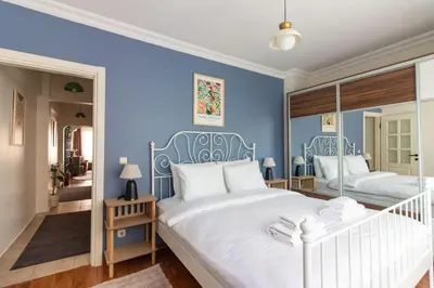 two beds in a bedroom with blue walls at Chic 2BR Gem on Moda Iconic Antiques Street in Istanbul