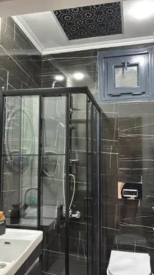 a bathroom with a shower with a glass door at Amora Suites in Istanbul
