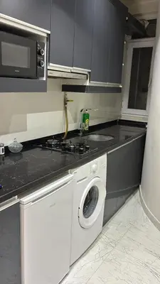 a kitchen with a washing machine and a microwave at Amora Suites in Istanbul