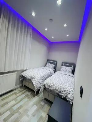 two beds in a room with purple ceilings at Amora Suites in Istanbul