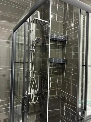 a shower with a glass door in a bathroom at Amora Suites in Istanbul