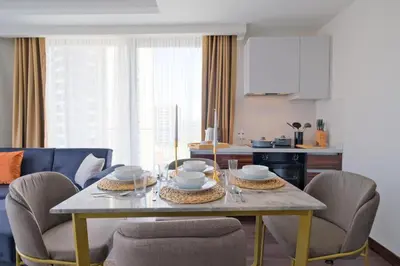 a dining room with a table and chairs at Modern Furnished Apartments in Istanbul Basaksehir By Iradah Gayrimenkul in Basaksehir