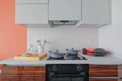a kitchen with two pots and pans on a stove at Modern Furnished Apartments in Istanbul Basaksehir By Iradah Gayrimenkul in Basaksehir