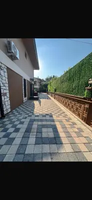 a building with a tiled sidewalk next to a building at Lina Garden Villa in Sapanca