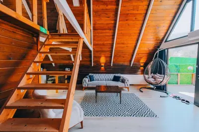 a living room with a staircase and a couch at Mert Bungalov-Ay Evi in Sapanca