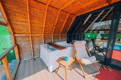 a tub and a chair on a deck with a pool at Mert Bungalov-Ay Evi in Sapanca