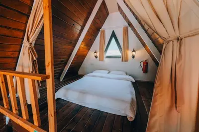 a bedroom with a bed in a wooden house at Mert Bungalov-Ay Evi in Sapanca