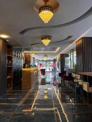 a hotel lobby with a bar and a dining area at City Night Hotels Ümraniye in Umraniye