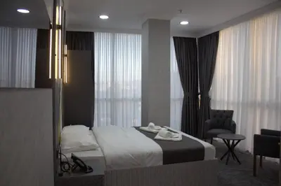 a hotel room with a bed and a chair at City Night Hotels Ümraniye in Umraniye