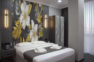 a bedroom with a large bed with a floral wallpaper at City Night Hotels Ümraniye in Umraniye
