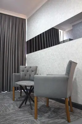 a waiting room with two chairs and a table at City Night Hotels Ümraniye in Umraniye