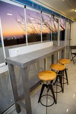 a bar with two stools and a large window at Dream Flat in Istanbul