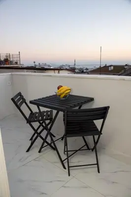 a black table with two chairs and bananas on it at Dream Flat in Istanbul