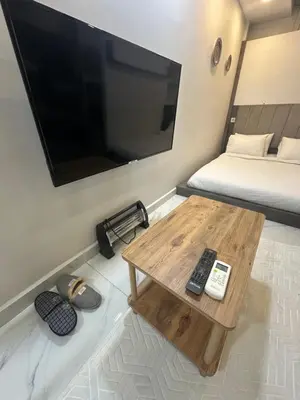 a room with a tv and a wooden coffee table at Dream Flat in Istanbul