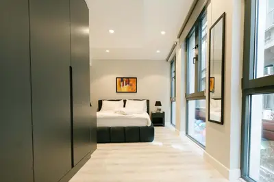 a bedroom with a bed and some windows at DeCamondo Residence Karaköy in Istanbul