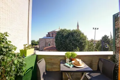 a table on a balcony with a hat on it at ELİTE HOTEL By MK in Istanbul