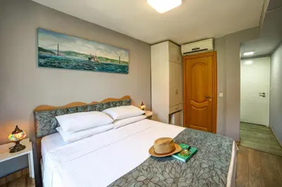 a bedroom with a bed with a hat on it at ELİTE HOTEL By MK in Istanbul