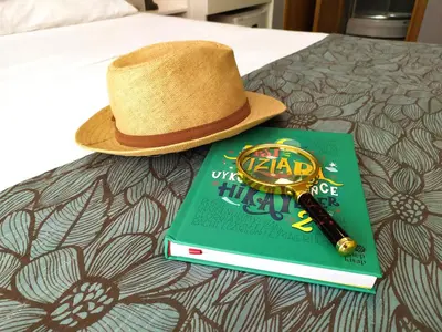 a hat and a book and a pen on a bed at ELİTE HOTEL By MK in Istanbul