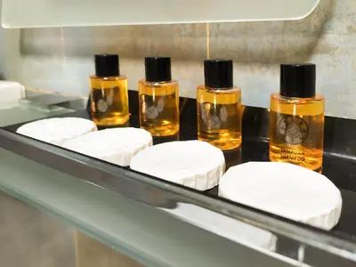 four bottles of essential oils sitting on a shelf at ELİTE HOTEL By MK in Istanbul