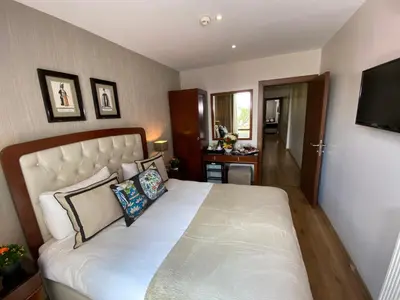 a bedroom with a large white bed and a television at Four Doors Hotel in Istanbul